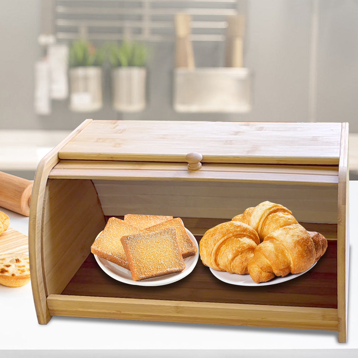 Open bamboe broodtrommel met croissants en geroosterd brood op bordjes