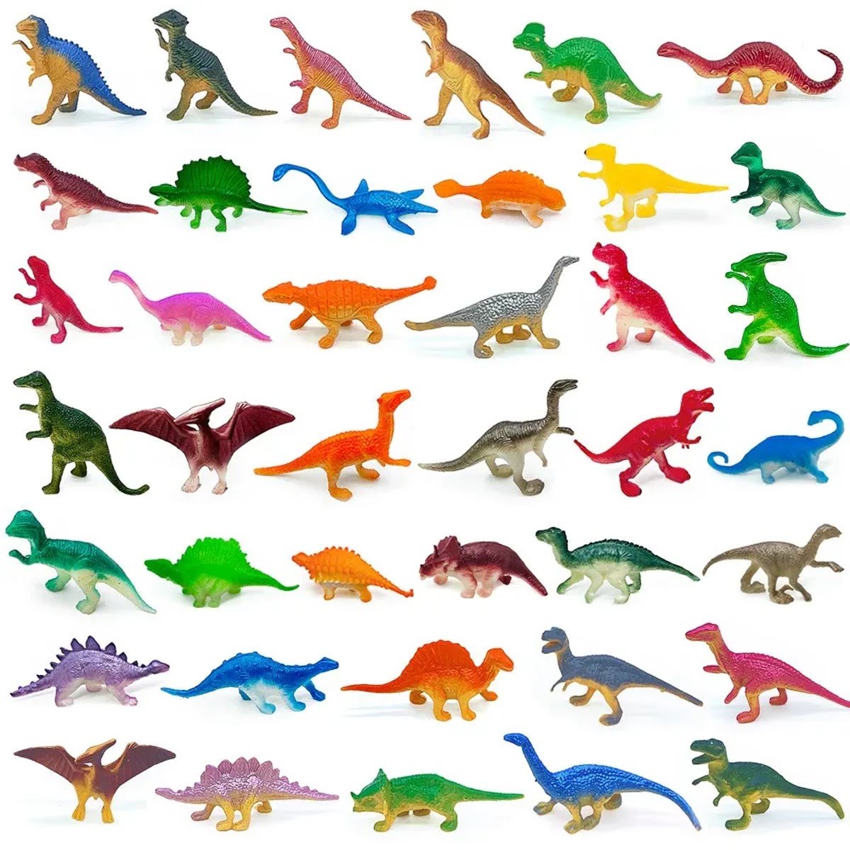 Een selectie van de dinosaurusfiguurtjes in rijen op een witte achtergrond, in veel kleuren en vormen