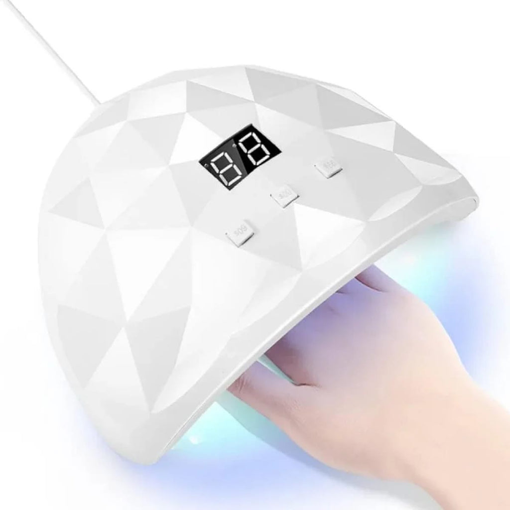 Witte nagellamp met display boven een hand