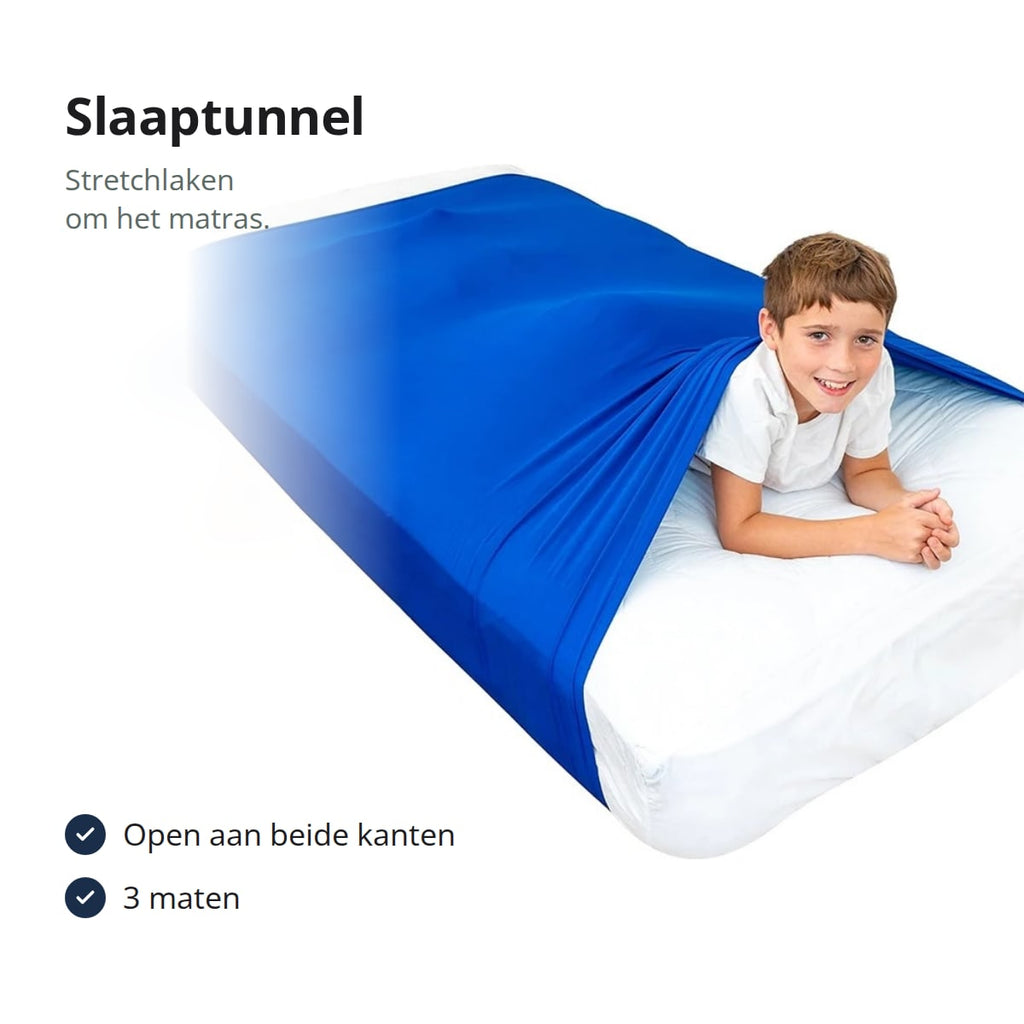 Slaaptunnel: blauw stretchlaken om een matras met een lachende jongen eronder