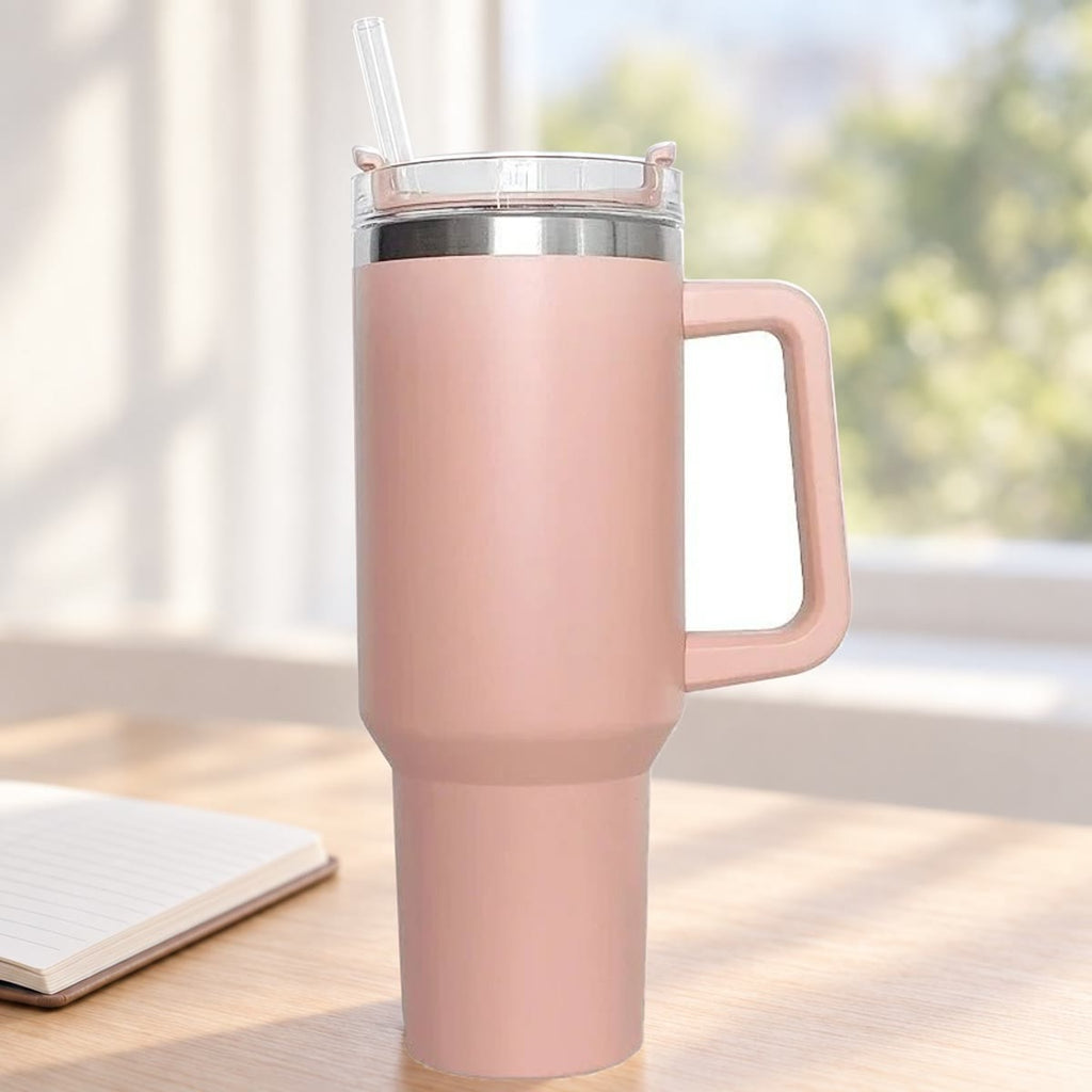Lichtroze drinkbeker met handvat en rietje op een licht bureau